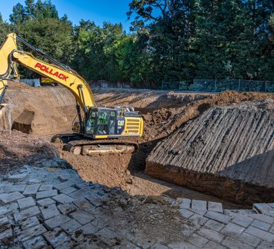 Gary Pollack Construction Caterpillar hydraulic excavator performing foundation excavation and rough grading at a residential construction site in Atherton, California